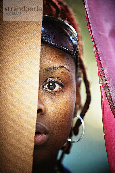 A African American woman staring at the camera.