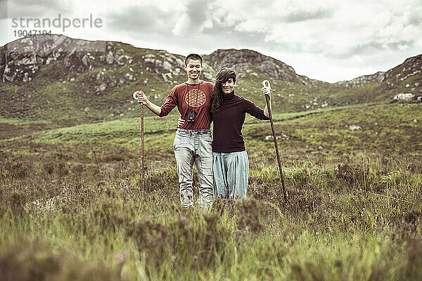 Zwei Wanderinnen stehen lächelnd in den Bergen