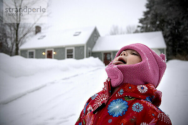 Young girl playing in snow.