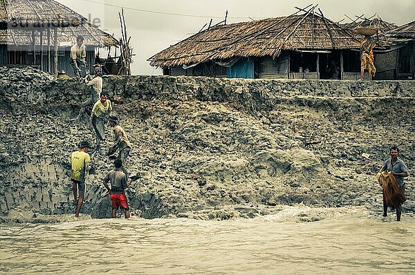 Sunderban  Bangladesch  etwa im Juli 2012: Einheimische Männer arbeiten im Schlamm in der Nähe ihrer Häuser und des Flusses in Sunderban  Bangladesch. Dokumentarischer Leitartikel  Asien
