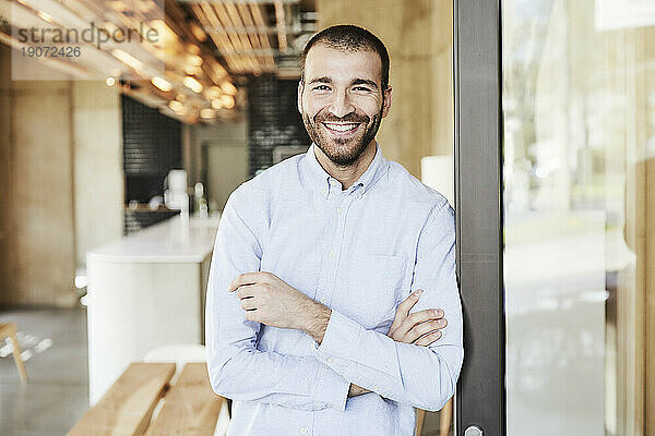 Portrait of smiling businessman in modern office