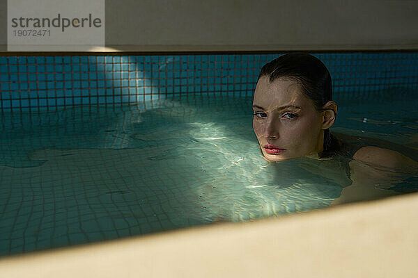Beautiful woman enjoying in hot tub at spa