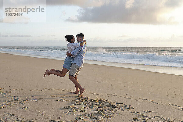 Boyfriend and girlfriend enjoying together at beach