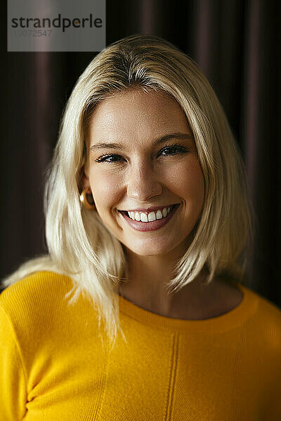 Portrait of happy blond woman smiling