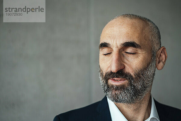 Mature businessman with eyes closed