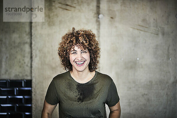 Portrait of laughing woman with stained T-shirt