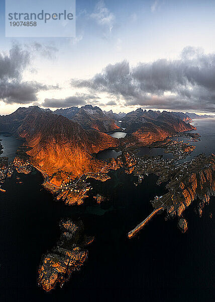 Aerial panoramic view of the coastal village of Tind framed by mountains at sunset  Lofoten Islands  Nordland  Norway  Scandinavia  Europe