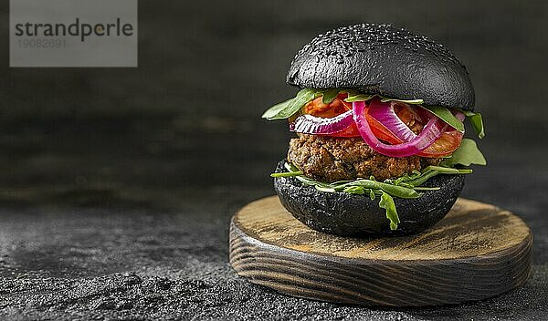 Vorderansicht Veggie Burger mit schwarzen Brötchen Schneidebrett