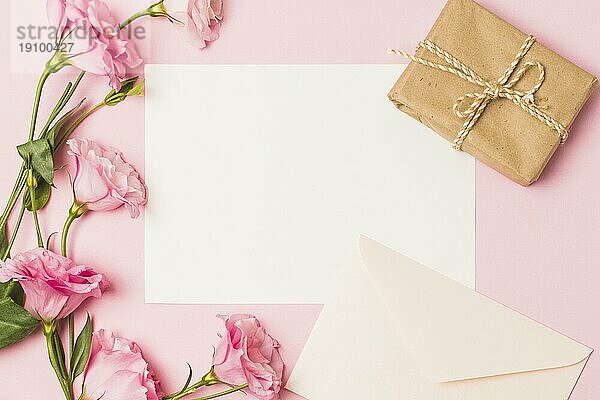 Blankopapier mit Umschlag frische rosa Blume braun eingewickelt Geschenkbox rosa Hintergrund