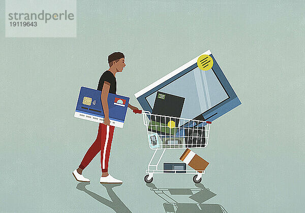 Männlicher Verbraucher mit Kreditkarte schiebt Einkaufswagen mit Technologiewaren