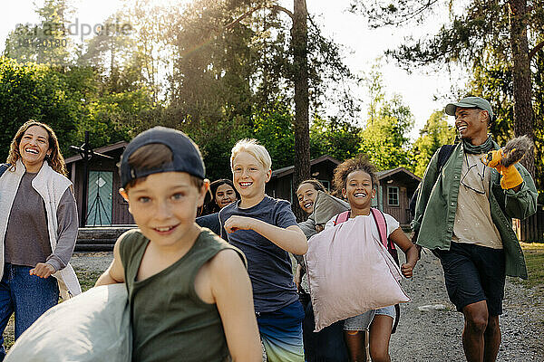 Aufgeregte Kinder und Betreuer rennen gemeinsam im Ferienlager