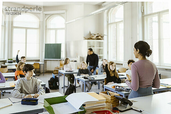 Lehrerin unterrichtet Schüler im Klassenzimmer sitzend