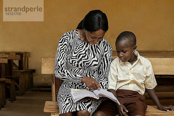 Afrikanische Frau unterrichtet Kinder