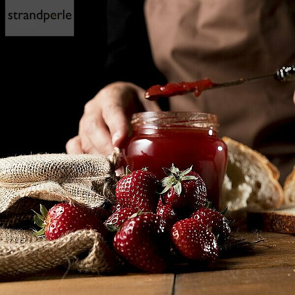 Vorderansicht Chefkoch mit Glas Erdbeermarmelade