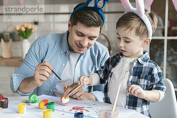 Vater Sohn Malerei Eier Ostern zusammen