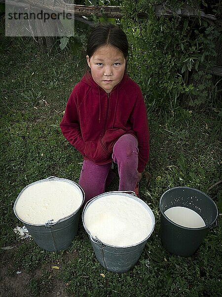 Kleines asiatisches Mädchen mit frisch gemolkener Milch in Eimern  Razdolnoe  Kirgistan  Asien