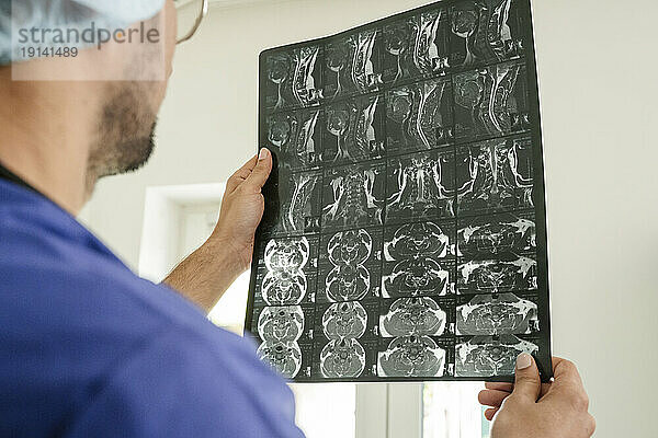 Doctor examining x-ray at healthcare clinic