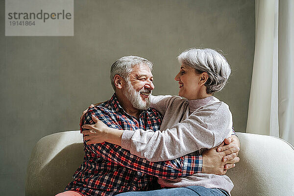 Romantic mature couple embracing at home