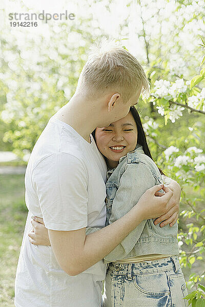 Happy young couple embracing at park