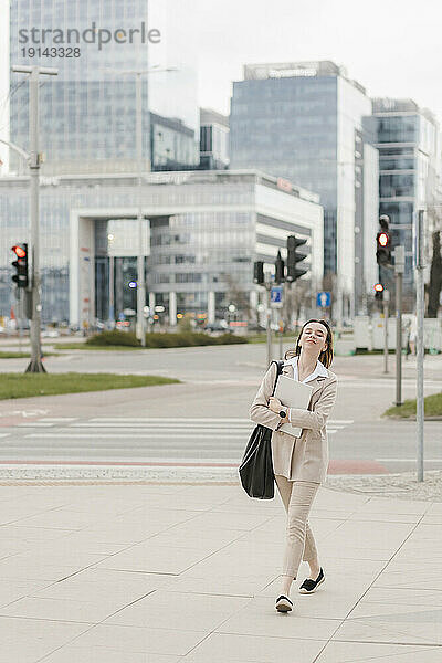 Lächelnde Geschäftsfrau geht auf Fußweg