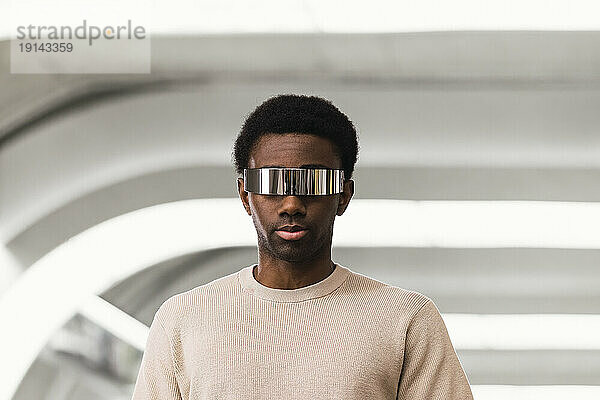Cool young man wearing cyber glasses  portrait