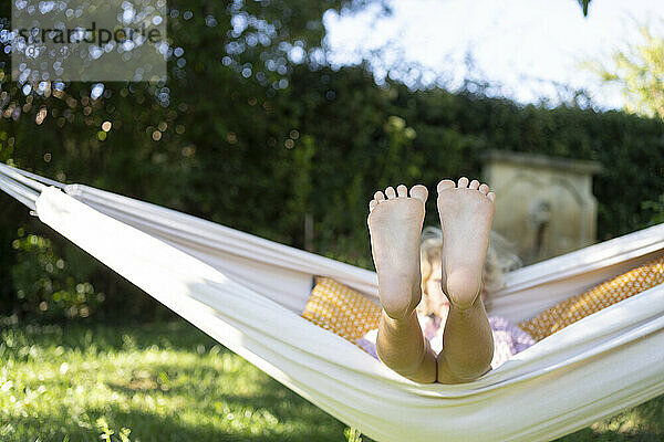 Girl with feet up relaxing in hammock