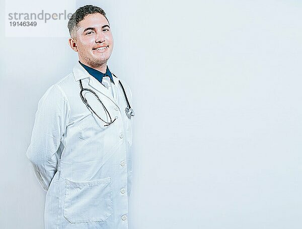 Porträt eines lächelnden jungen Arztes isoliert. Porträt von lateinischen Arzt isoliert mit Kopie Raum