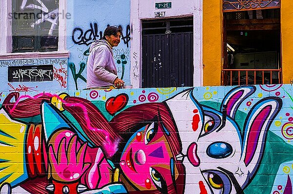 Bogota  KOLUMBIEN im Dezember 2015: Eine alte Frau sitzt auf einem Street Art Kunstwerk  das eine junge rosa Prinzessin zeigt. Street Art ist in Bogota sehr beliebt