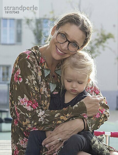 Mutter hält Kind  Mädchen  blond  2 Jahre  in Arm  Brille  Stuttgart  Baden-Württemberg  Deutschland  Europa
