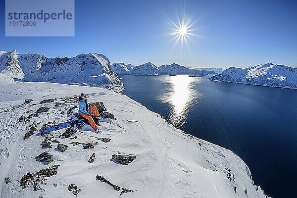 Norway  Troms og Finnmark  Female hiker admiring Sessoyfjord from Brosmetind mountain