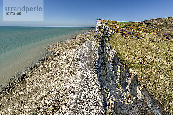 Atlantic coasts with chalk cliffs under blue sky on sunny day