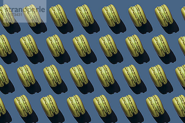 Background of green macaroons over blue background