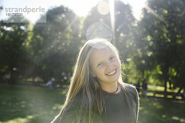 Smiling girl in park on sunny day