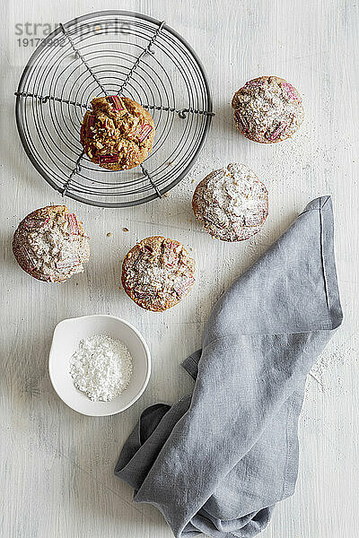 Studio shot of rhubarb muffins with powdered sugar on cooling rack
