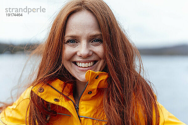 Smiling redhead woman with long hair