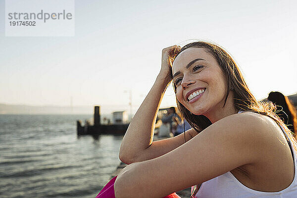Happy woman at promenade on sunny day