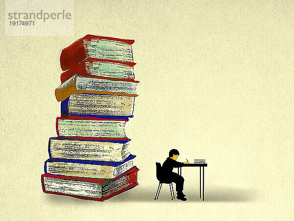 Stack of oversized books behind boy studying at desk