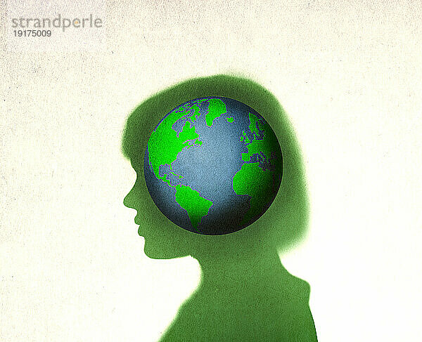 Planet Earth inside silhouette of woman
