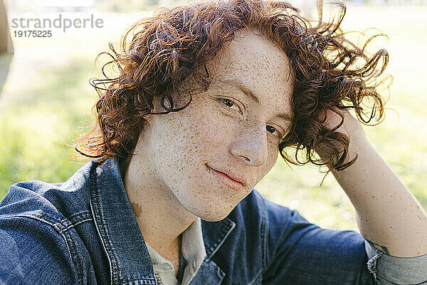 Smiling redhead man with curly hair