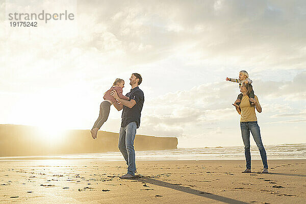 Glückliche Familie  die gemeinsam Spaß am Strand hat