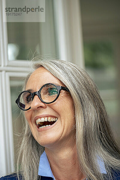 Happy mature businesswoman with gray hair