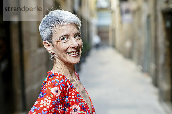 Happy mature woman in alley