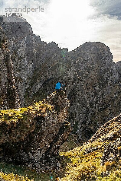 Ein junger Mann genießt die Aussicht auf dem Gipfel des Berges Aiako Harria oder Peñas de Aya in der Gemeinde Oiartzun  Guipúzcoa. Baskenland