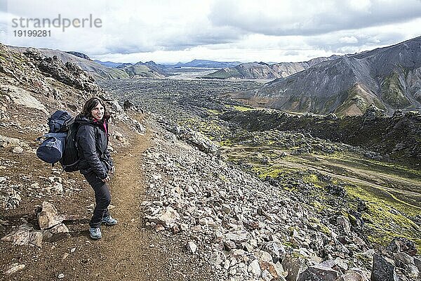 Eine junge Frau kurz vor dem Ziel der 54 km langen Wanderung von Landmannalaugar  Island  Europa