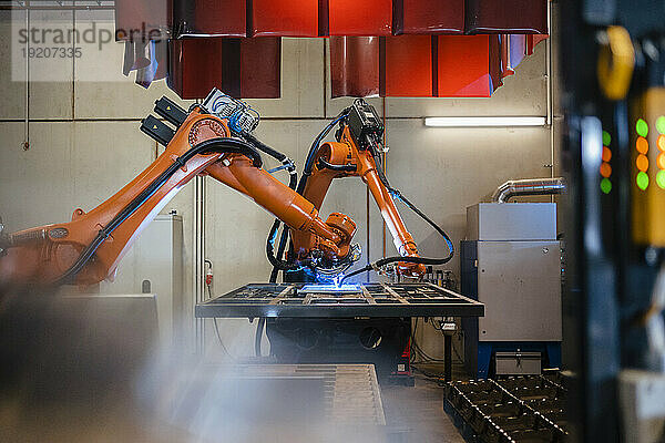 Industrielle Roboterarme schweißen in der Fabrik