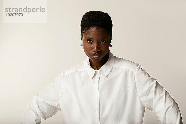 Young woman with short hair against white background