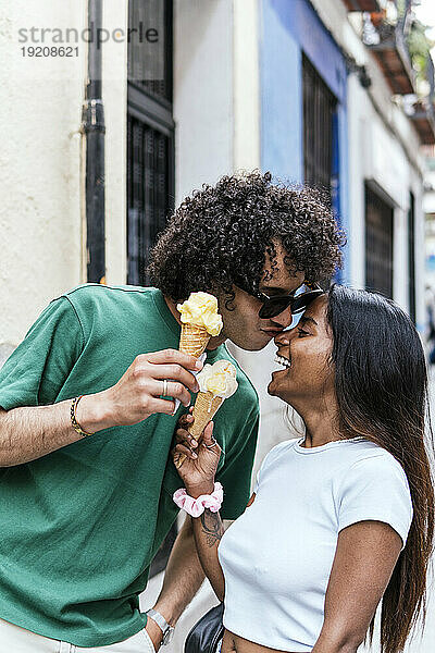 Liebevolles Paar hält Eistüte auf der Straße