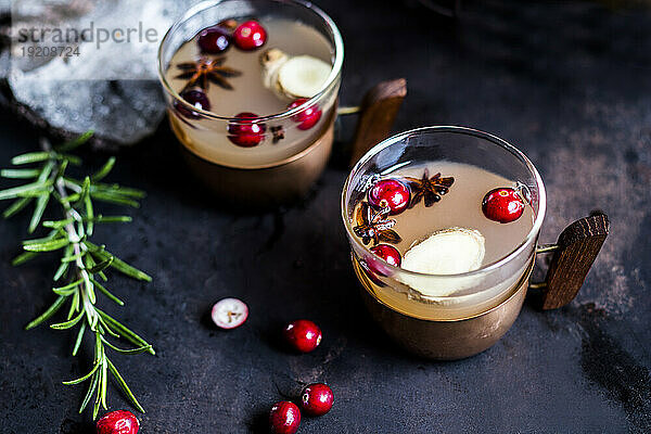 Cups of Moscow mule drink with spices and cranberries