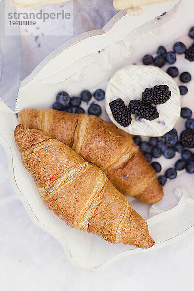 Croissants with berries in tray