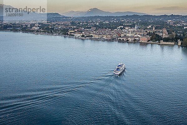 Italy  Veneto  Lazise  Aerial view of ferry arriving at lakeshore town
